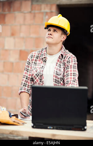 Carpenter worker with laptop, Debica, Poland. Stock Photo