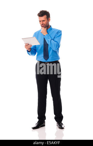 Businessman holding digital tablet and grimacing Debica, Poland Stock Photo