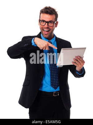 Shocked businessman showing on digital tablet Debica, Poland Stock Photo