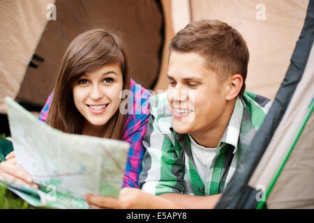 Couple looking at map in tent Debica, Poland Stock Photo