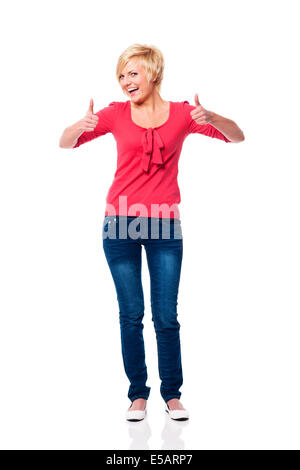 Beautiful blonde woman showing thumbs up Debica, Poland Stock Photo
