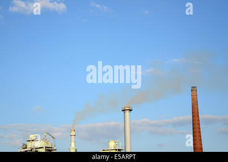 smoke from chimneys on a blue sky Stock Photo