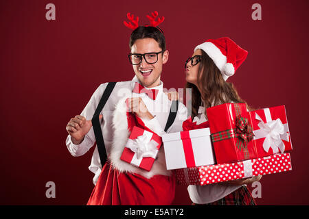 Funny couple with stack of Christmas gifts  Debica, Poland Stock Photo