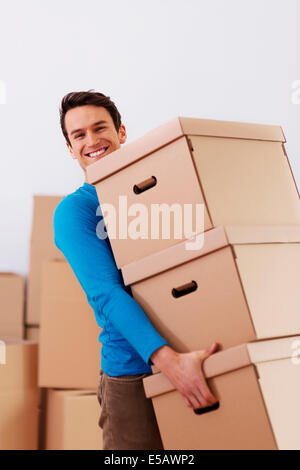 Handsome man carrying stack of boxes Debica, Poland Stock Photo