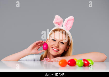 Blonde woman with bunny ears and Easter eggs Debica, Poland Stock Photo