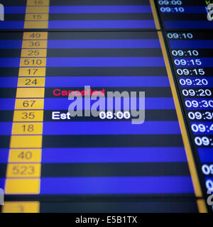 Airport arrival board in airport terminal. Flight cancelled. Stock Photo