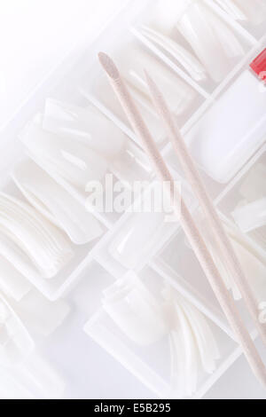 Manicure tools , Orange wood sticks for removal cuticle on white plastic tips background Stock Photo