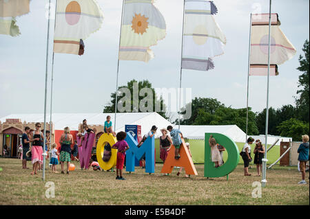 WOMAD music festival, Charlton Park, UK. 25th July, 2014. Blazing heat and humidity on the first full day of the festival culminates in a flash terrential downpoor during late afternoon. It didn't put the festival goers off and may of them only needed to seek cover for a short time before the sun shone again. More hot weather is expected over the weekend. Stock Photo