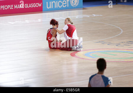 SECC, Glasgow, Scotland, UK, Saturday, 26th July, 2014. England player Serena Guthrie receives treatment on the field of play during a Preliminary Netball Match at the Glasgow 2014 Commonwealth Games Stock Photo