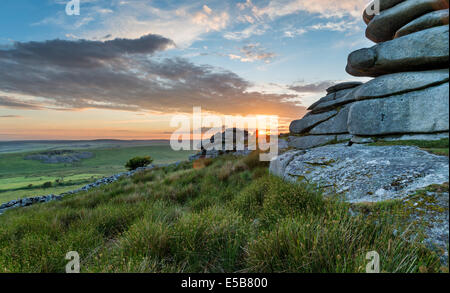 Beautiful sunset over a granite tor at the Cheesewring on Stowes Hill near the Minions on Bodmin Moor in Cornwall Stock Photo