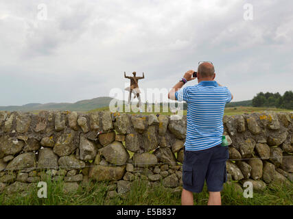 Dumfries, Scotland, UK. 25th July, 2014. Festival goers gather under the Wickerman on day two at Dundrennan on July 26, 2014 in Dumfries, United Kingdom. Credit:  Sam Kovak/Alamy Live News Stock Photo