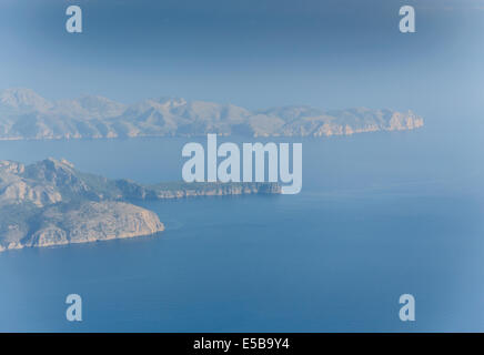 Blue Earth Mallorca. Misty blue morning aerial view of north Mallorca with Formentor peninsula and lighthouse far away. Stock Photo