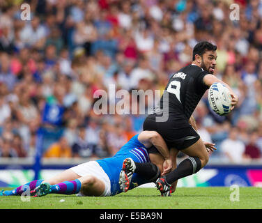 Glasgow, Scotland. 25th July, 2014. Glasgow Commonwealth Games. Sherwin Stowers, of New Zealand is tackled by Scotland's Sean Lamont. Scotland versus New Zealand in The Rugby 7's from Ibrox Stadium. Credit:  Action Plus Sports/Alamy Live News Stock Photo