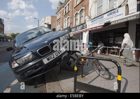 London, London, UK. 26th July, 2014. A driver managed to mount bicycle security stands in Tooting Bec, south west London. According to police no one was hurt when the BMW hit the curb and managed to crash on top of the static bike stands in Upper Tooting Road. © Lee Thomas/ZUMA Wire/Alamy Live News Stock Photo