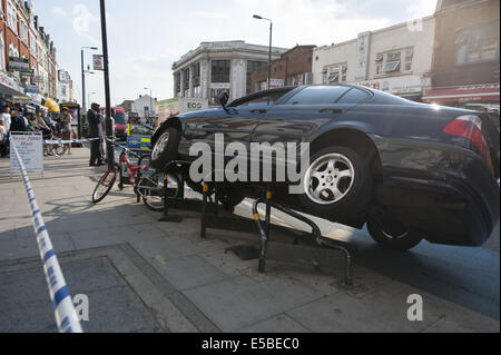 London, London, UK. 26th July, 2014. A driver managed to mount bicycle security stands in Tooting Bec, south west London. According to police no one was hurt when the BMW hit the curb and managed to crash on top of the static bike stands in Upper Tooting Road. © Lee Thomas/ZUMA Wire/Alamy Live News Stock Photo