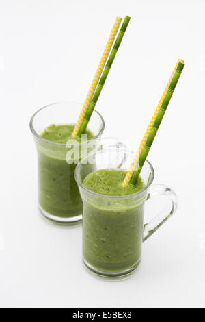 Two green smoothies in glass cups. Stock Photo