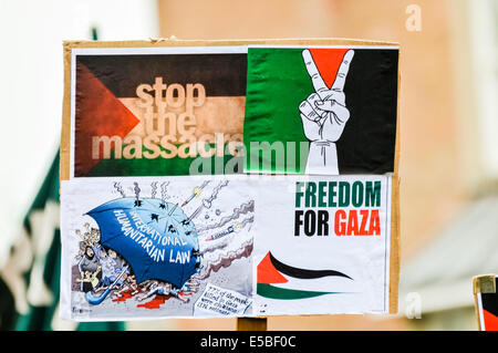 Belfast, Northern Ireland. 26 Jul 2014 - A protester holds up a poster saying 'Stop the massacre.  Freedom for Gaza' at a pro-Gaze/anti-Israeli protest rally Credit:  Stephen Barnes/Alamy Live News Stock Photo