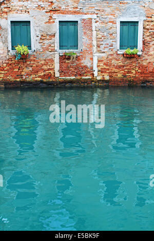 Reflection of three windows on the water in Venice Stock Photo