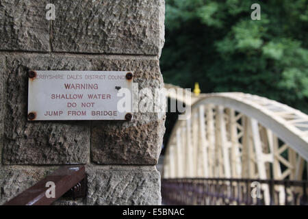 Warning Sign on Restored Jubilee Bridge in Matlock Bath which was built in 1887 to mark the Golden Jubilee of Queen Victoria Stock Photo