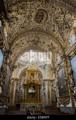 Ornate gold carving in Capilla de Rosario inside of the Church of Santo Domingo, completed in 1611 and located in Puebla Mexico. Stock Photo