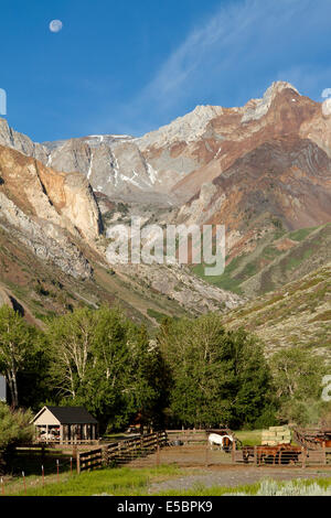 McGee creek pack station with a setting moon above Mt Baldwin (the highest peak) and the Sierra Nevada Mountains Stock Photo