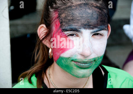 Demonstration against Israeli bombing of Gaza, 26.07.2014. Young woman with face painted in the colours of the Palestinian flag. Stock Photo