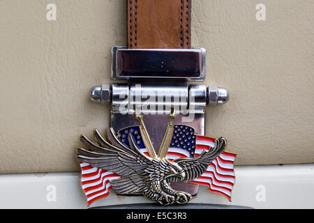 American Eagle and Flag on a Belt Buckle with leather Strap on a  1980 Zimmer Golden Spirit Stock Photo