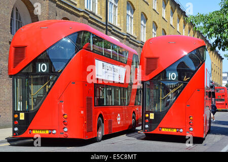 Pair of new red London Boris routemaster buses on bus stands during rest break in a one way street Stock Photo