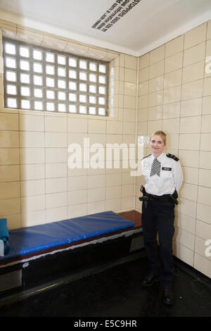 Metropolitan Police WPC woman officer in a Police station custody suite / suites / cell / cells in Twickenham. London UK