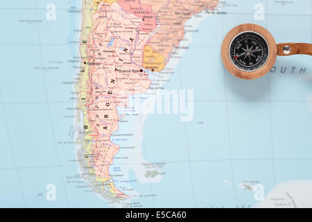 Compass on a map pointing at Argentina and planning a travel destination Stock Photo