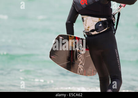 LAKE OF SANTA CROCE, ITALY - JULY 13, 2014: Kitesurfer launches his kite in the lake of Santa Croce Stock Photo