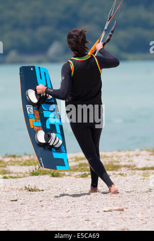 LAKE OF SANTA CROCE, ITALY - JULY 13, 2014: Kitesurfer launches his kite in the lake of Santa Croce Stock Photo