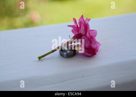 Wedding rings on a tropical pink flower Stock Photo