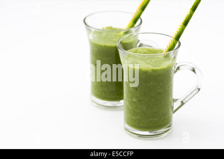 Two green smoothies in glass cups. Stock Photo