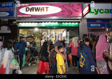 Upper Tooting Road, Tooting, London, UK. 28th July 2014. Hundreds of Muslims celebrate the beginning of Eid ul-Fitr at midnight in Tooting Bec, south west London. Upper Tooting Road was crowded with people eager to eat snacks, buy clothes or dance in the street. Credit:  Lee Thomas/Alamy Live News Stock Photo