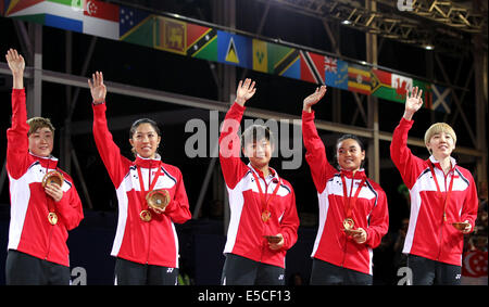 Glasgow, Scotland, UK. 27th July, 2014. Players of Singapore celebrate their victory on the podium during the awarding ceremony for the women's team final of table tennis at the 2014 Glasgow Commonwealth Games in Scotstoun Sports Campus in Glasgow, Scotland on July 27, 2014. Singapore defeated Malaysia 3-0 and won the gold medal. Credit:  Han Yan/Xinhua/Alamy Live News Stock Photo