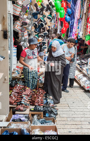 A vendor and a buyer at the market in the old city of Nazareth, Israel Stock Photo