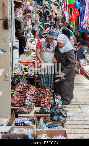 A vendor and a buyer at the market in the old city of Nazareth, Israel Stock Photo