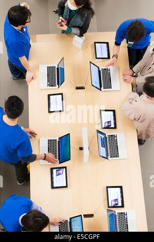 People at Apple store trying new MacBook computers. Ginza, Tokyo, Japan 2014 Stock Photo