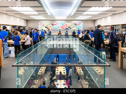 People at multi-storey Apple store trying new devices. Ginza, Tokyo, Japan 2014 Stock Photo