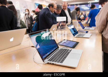 People at Apple store trying new MacBooks laptop computers. Ginza, Tokyo, Japan 2014 Stock Photo