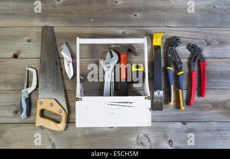 Over head view of basic home repair tools and holder on rustic wooden boards Stock Photo