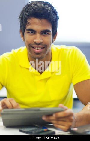 handsome male university student using tablet computer in lecture room Stock Photo
