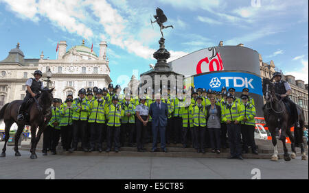 London, UK. 28 July 2014. L-R: Westminster Commander Alison Newcomb and Boris Johnson, Mayor of London pose with a 100-strong police team in Piccadilly Circus. Launch of the new 100-strong police officer initiative for West End. The Met Police's new Impact Zone Team will be dedicated to policing the West End's Leicester Square, Coventry Street, Piccadilly Circus and the immediate surrounding areas. Stock Photo