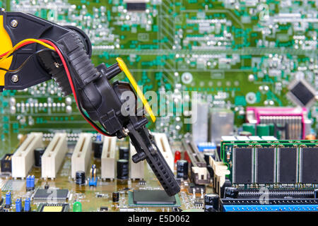 Robotic arm installing a computer chip Stock Photo