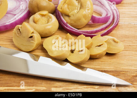 sliced mushrooms and onions on a cutting board Stock Photo