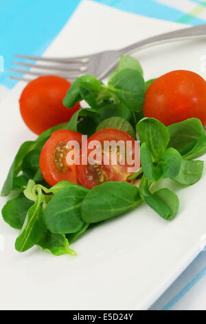 Corn salad with cherry tomatoes, close up Stock Photo
