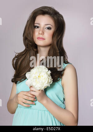 Nostalgia. Young Adorable Teen Girl with Peony Flower