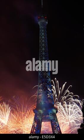 Fireworks at the bottom of the Eiffel Tower in blue by night on Bastille Day French National Holiday Stock Photo