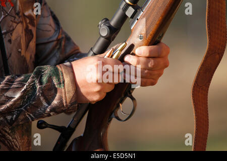 Man Loading Rifle A person loading a bolt-action rifle with cartridges Stock Photo - Alamy